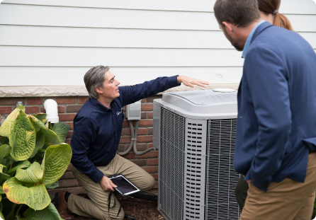 Home Inspector reviewing exterior inspection items with homebuyers