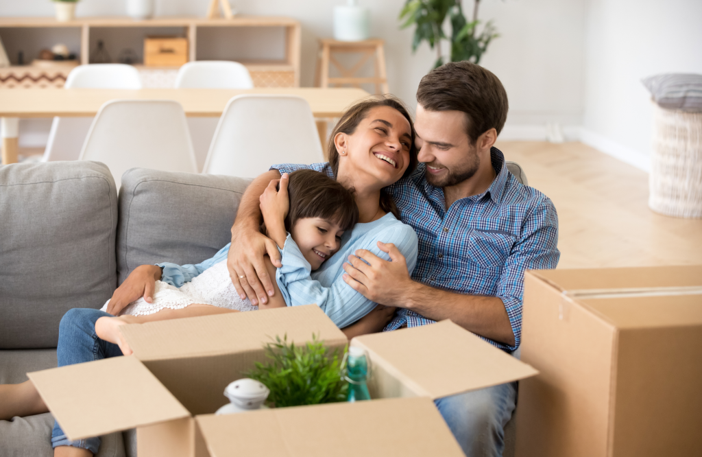family sitting next to moving boxes